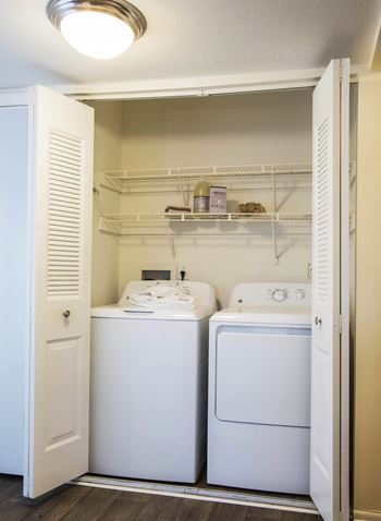 A small laundry room with a washer and dryer